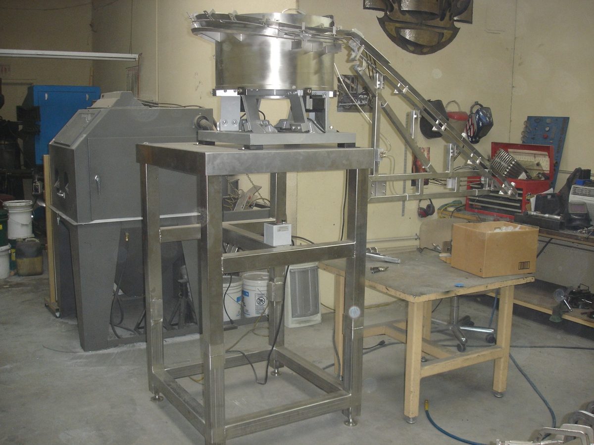 Stainless steel table and frame for a feeder system