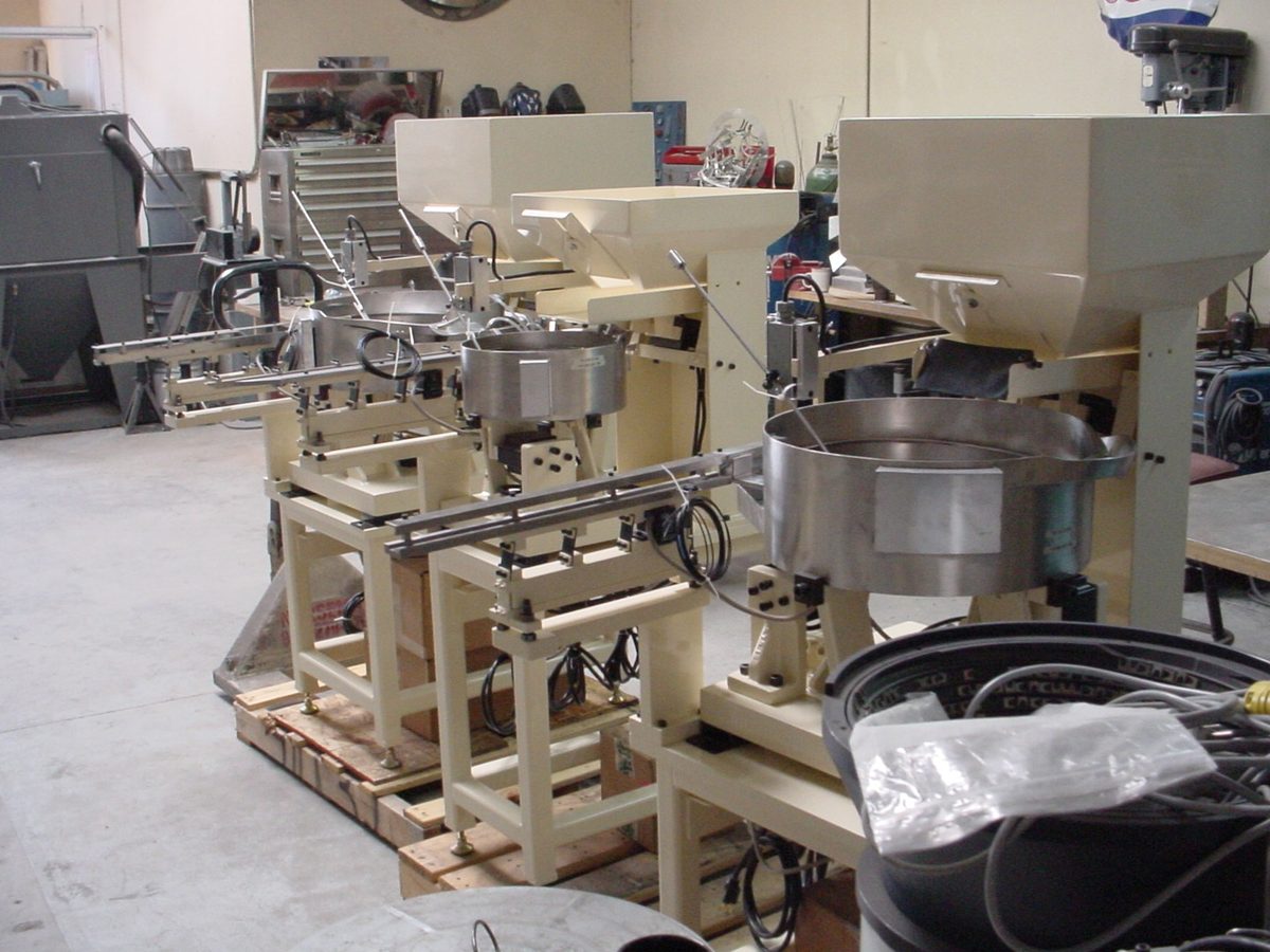Multi-station feeder line with bowls and hoppers